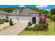 Beautiful exterior view of a well-maintained home with a paver driveway and lush landscaping at 4155 Barletta Ct, Wesley Chapel, FL 33543
