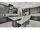 Modern kitchen with dark cabinetry, quartz countertops, and stainless steel appliances at 4155 Barletta Ct, Wesley Chapel, FL 33543