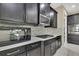 Close-up of kitchen featuring dark cabinets, stainless steel appliances, and mosaic backsplash at 4155 Barletta Ct, Wesley Chapel, FL 33543