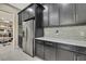 Kitchen featuring stainless steel appliances, dark cabinetry, and a walk-in pantry at 4155 Barletta Ct, Wesley Chapel, FL 33543