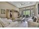 Spacious living room with high ceilings, a ceiling fan, and elegant furniture at 4155 Barletta Ct, Wesley Chapel, FL 33543
