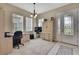 Well-lit office space with modern desk setup and a view of the front yard at 4155 Barletta Ct, Wesley Chapel, FL 33543