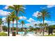 Resort-style pool area with palm trees, lounge chairs, and a clear blue sky at 4155 Barletta Ct, Wesley Chapel, FL 33543