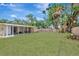 Large backyard features a well-maintained lawn and a covered patio, perfect for relaxing and outdoor activities at 4714 W Vasconia St, Tampa, FL 33629