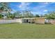 Well-manicured backyard with lush green grass and a covered patio, ideal for entertaining or enjoying the outdoors at 4714 W Vasconia St, Tampa, FL 33629