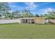 Wide view of the house and lush, expansive backyard with green grass and a white fence at 4714 W Vasconia St, Tampa, FL 33629