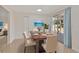 Elegant dining room with a wood table set for six, complemented by natural light and sliding glass doors at 4714 W Vasconia St, Tampa, FL 33629