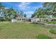 Charming home with a well-kept lawn and inviting curb appeal, showcasing a cozy and welcoming atmosphere at 4714 W Vasconia St, Tampa, FL 33629