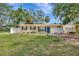 Charming yellow home with blue shutters, a well-maintained lawn and welcoming curb appeal on a sunny day at 4714 W Vasconia St, Tampa, FL 33629