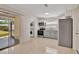 Modern kitchen with stainless steel appliances, gray cabinets, and a sliding glass door leading to the backyard at 4714 W Vasconia St, Tampa, FL 33629
