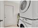 Functional laundry room with stacked washer and dryer units, maximizing space and efficiency at 4714 W Vasconia St, Tampa, FL 33629