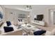 Bright living room featuring modern furnishings, a stylish rug, and a ceiling fan for added comfort at 4714 W Vasconia St, Tampa, FL 33629