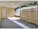 Covered patio with concrete floor and a wooden privacy fence, and a door to access to the interior at 4714 W Vasconia St, Tampa, FL 33629