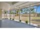 Relaxing screened porch overlooking the backyard and featuring white gravel and tropical landscaping at 4714 W Vasconia St, Tampa, FL 33629