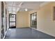Covered porch with grey concrete floor, cream siding, and a sliding glass door that leads into the interior at 4714 W Vasconia St, Tampa, FL 33629