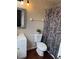 Cozy bathroom with neutral walls, vanity with sink, updated lighting, and a shower with a patterned curtain at 4793 Pleasant Ave, Palm Harbor, FL 34683