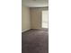 A cozy bedroom features neutral walls, plush carpeting, and a window providing natural light at 4793 Pleasant Ave, Palm Harbor, FL 34683