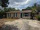 Cozy single-story home featuring neutral siding, green shutters, well-maintained landscaping, and a spacious driveway at 4793 Pleasant Ave, Palm Harbor, FL 34683