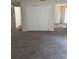Spacious living room featuring new carpet and ample natural light from a window adjacent to a large closet at 4793 Pleasant Ave, Palm Harbor, FL 34683