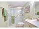 Bathroom with a walk-in shower, white vanity, a decorative mirror and green walls at 4801 Airport Rd # 211, Zephyrhills, FL 33542