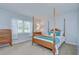 Bedroom with a four-poster bed, wood furniture and natural light from the window at 4801 Airport Rd # 211, Zephyrhills, FL 33542