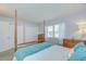 Bedroom with a four-poster bed, natural light from the window, and closet at 4801 Airport Rd # 211, Zephyrhills, FL 33542
