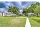 Beautifully landscaped grounds featuring well maintained grass, mature trees, and covered seating areas at 4801 Airport Rd # 211, Zephyrhills, FL 33542