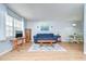 Bright living room features wood flooring, area rug, and comfortable seating at 4801 Airport Rd # 211, Zephyrhills, FL 33542