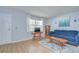 Bright living room features wood flooring, area rug, and comfortable seating at 4801 Airport Rd # 211, Zephyrhills, FL 33542