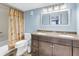 Well-lit bathroom featuring a double sink vanity, shower with curtain, and neutral finishes at 4900 Brittany S Dr # 611, St Petersburg, FL 33715