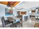 Elegant dining area with a modern chandelier adjacent to an open kitchen and breakfast bar at 4900 Brittany S Dr # 611, St Petersburg, FL 33715