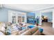 Comfortable living room with a TV and balcony doors overlooking scenic water views at 4900 Brittany S Dr # 611, St Petersburg, FL 33715