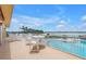 Charming patio with comfortable seating overlooking the sparkling pool and waterfront view at 4900 Brittany S Dr # 611, St Petersburg, FL 33715
