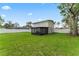 Expansive backyard with a dark screened-in porch and white privacy fence at 4918 Stolls Ave, Tampa, FL 33615