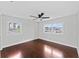 This bedroom features hardwood floors, ceiling fan, and two windows letting in plenty of natural light at 4918 Stolls Ave, Tampa, FL 33615