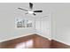 This bedroom features hardwood floors, closet and a window letting in plenty of natural light at 4918 Stolls Ave, Tampa, FL 33615