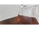 Bright bedroom features hardwood floors, a ceiling fan, and a closet with double doors at 4918 Stolls Ave, Tampa, FL 33615