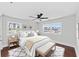 This staged bedroom offers a spacious layout, ceiling fan, hardwood floors, and lots of natural light at 4918 Stolls Ave, Tampa, FL 33615