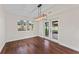 Bright dining area featuring wood floors, modern light fixture, and sliding glass doors to the outside at 4918 Stolls Ave, Tampa, FL 33615