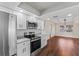 Modern kitchen with stainless steel appliances, granite countertops, and white cabinets at 4918 Stolls Ave, Tampa, FL 33615