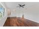 Bright living room with hardwood floors, large window, ceiling fan, and fresh white walls at 4918 Stolls Ave, Tampa, FL 33615