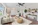 Stylish living room with modern decor, a ceiling fan, and hardwood floors at 4918 Stolls Ave, Tampa, FL 33615