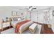 Stylish bedroom features natural light, hardwood floors, a ceiling fan, and closet space at 4918 Stolls Ave, Tampa, FL 33615