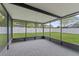 Enclosed screened patio with ample space for outdoor entertaining and enjoying the backyard view at 4918 Stolls Ave, Tampa, FL 33615
