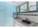 Cozy bathroom featuring stone countertops, integrated sink, and updated fixtures at 5377 Springwood Blvd, Pinellas Park, FL 33782