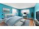 Cozy bedroom with blue walls, a large bed, and dedicated workspace with lots of light at 5377 Springwood Blvd, Pinellas Park, FL 33782