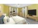 Comfortable bedroom with yellow walls, work desk, and a bright window at 5377 Springwood Blvd, Pinellas Park, FL 33782