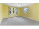 Sunlit bedroom with neutral carpet, a ceiling fan, and multiple windows at 5377 Springwood Blvd, Pinellas Park, FL 33782