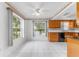 Sunlit dining area with a view, featuring white-tile flooring and convenient access to kitchen at 5377 Springwood Blvd, Pinellas Park, FL 33782