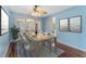 Well-lit dining room with a modern table, chairs, and view to the backyard at 5377 Springwood Blvd, Pinellas Park, FL 33782